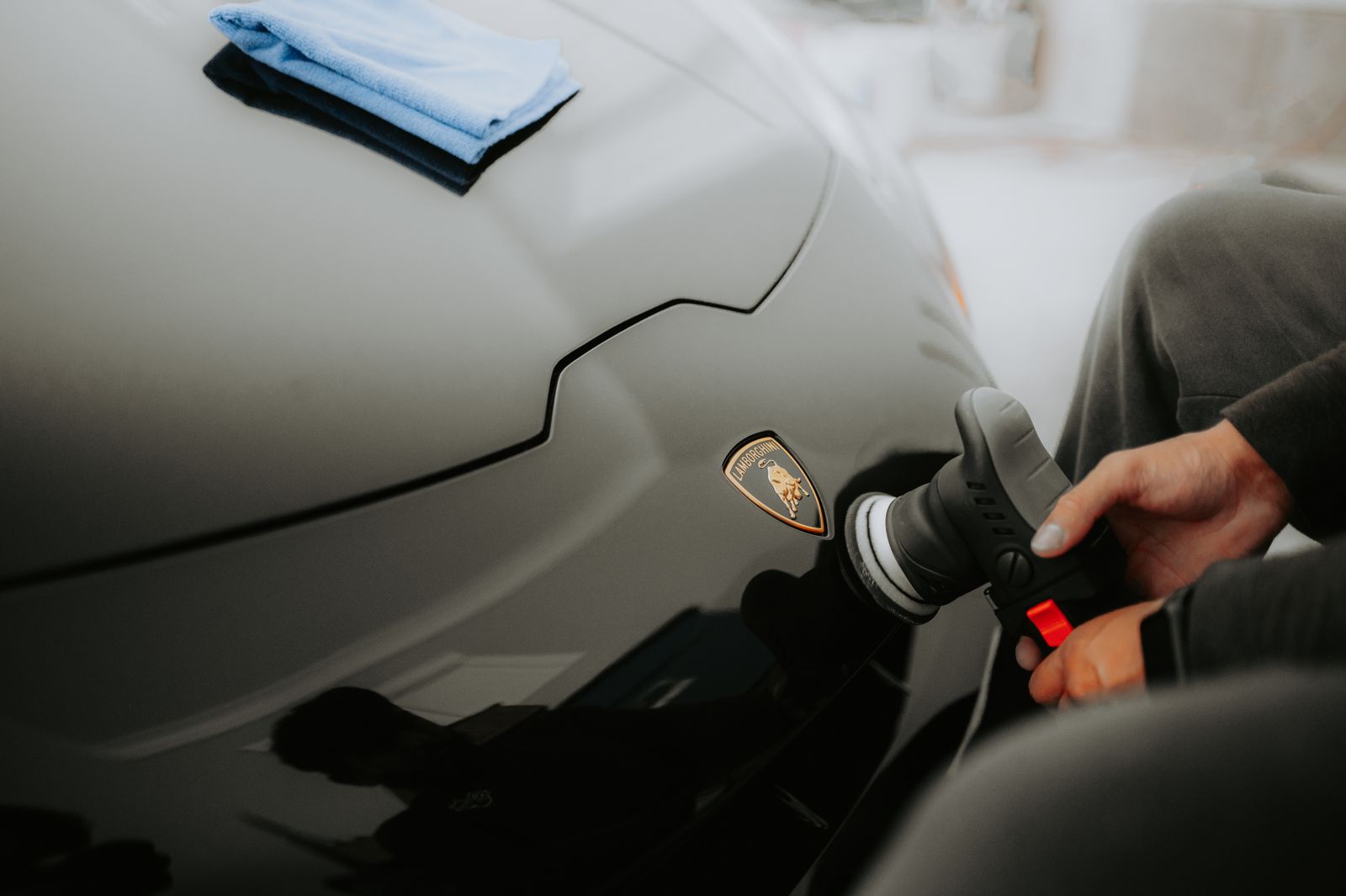 Machine polishing a sports car panel