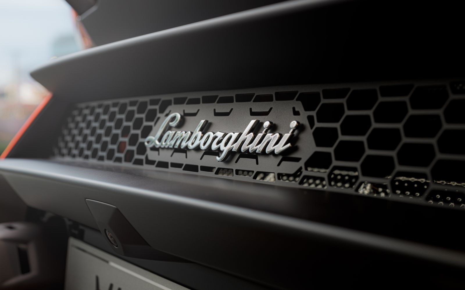 Close-up of a sports car grille and emblem