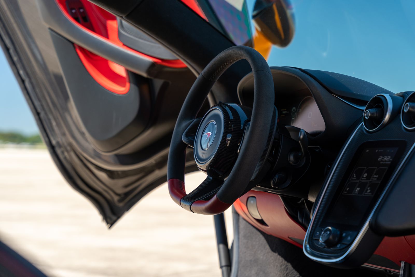 McLaren interior with open door and steering wheel