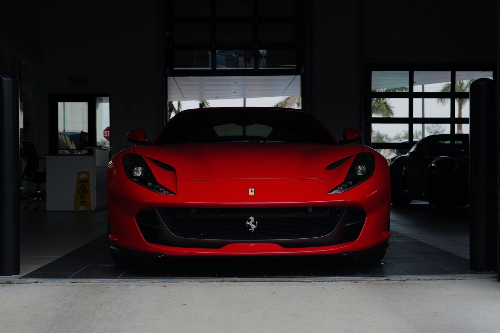 Finished red sports car ready for handover in the bay