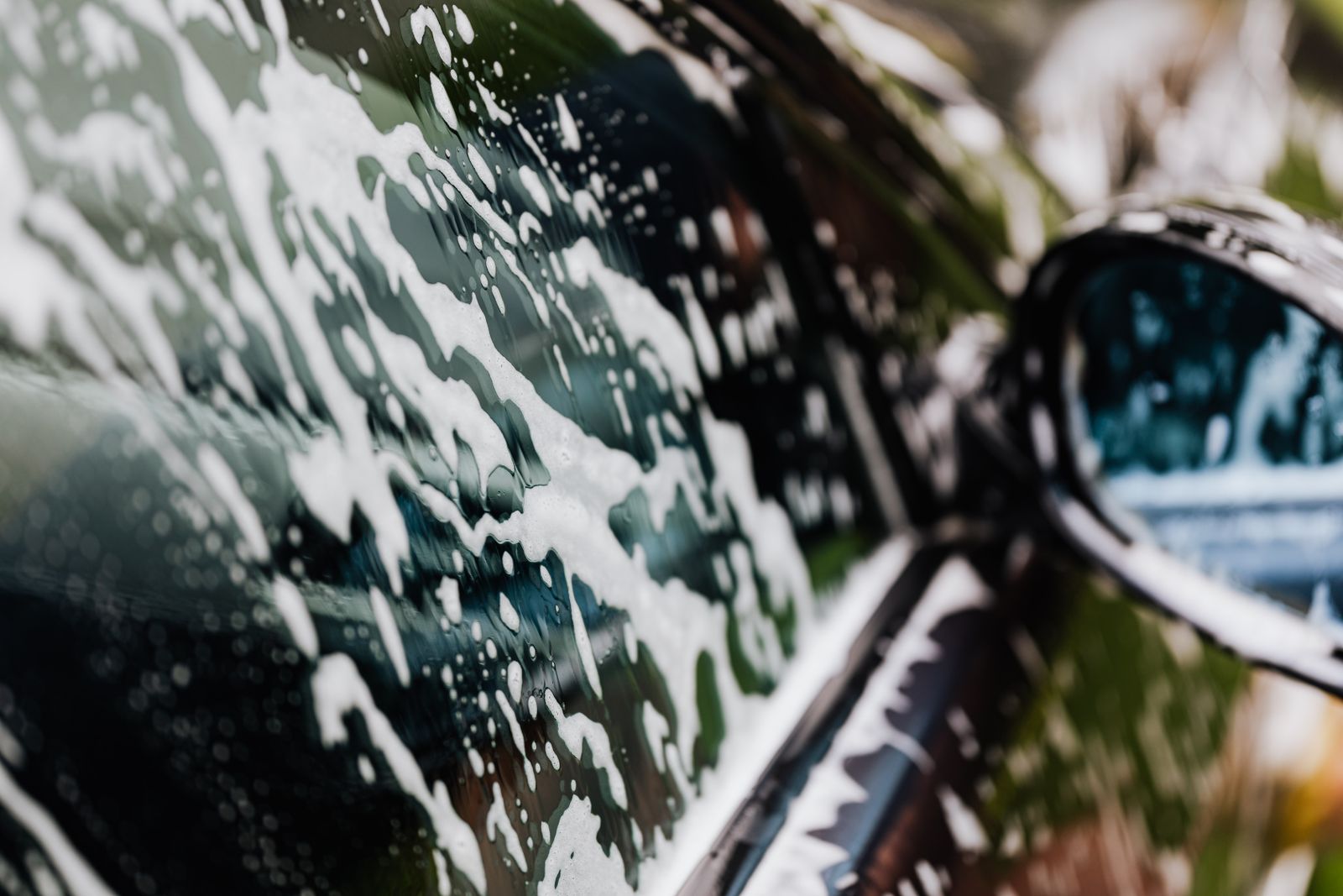 Car covered in foam during decontamination wash